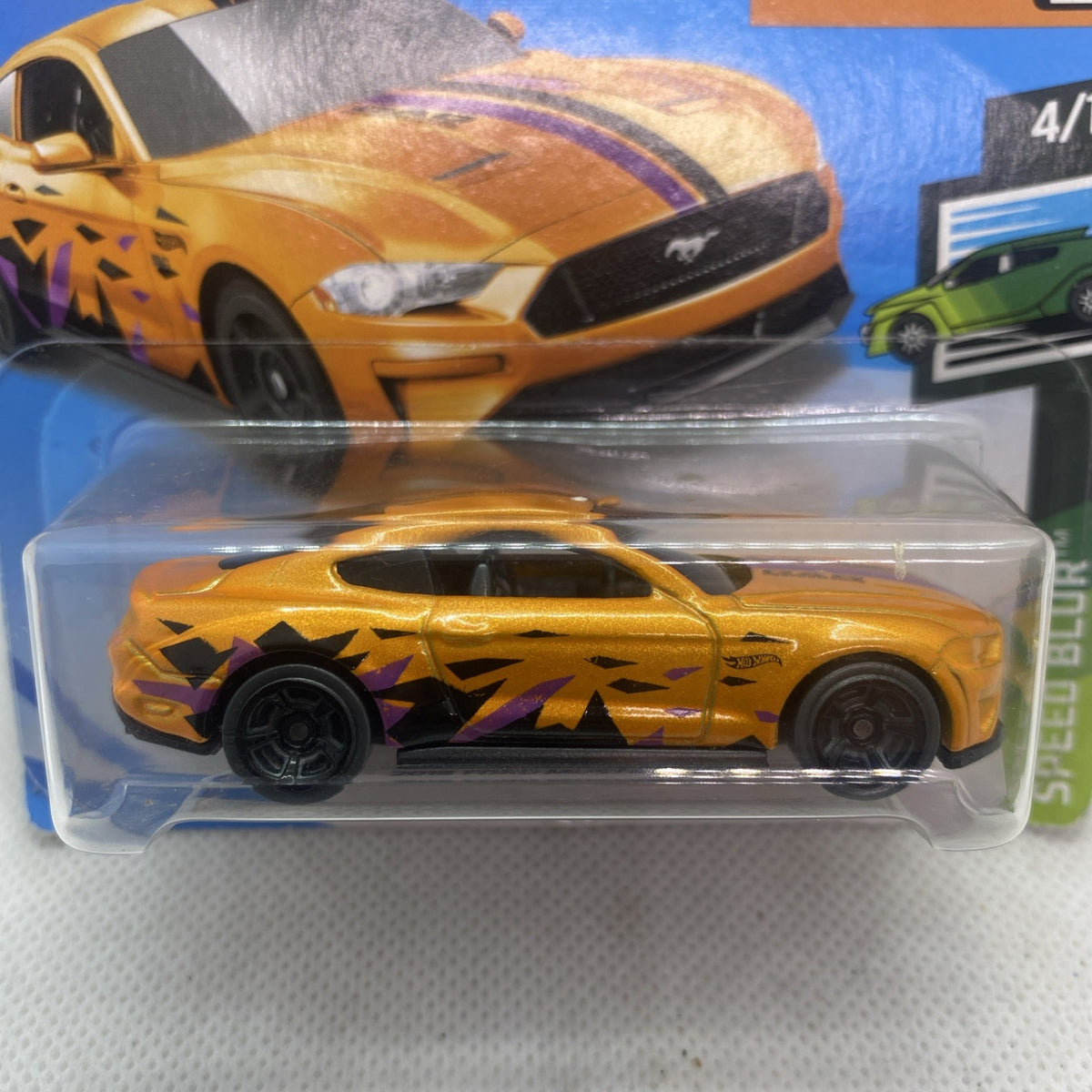 Orange Speed Blur die-cast car close-up in clear blister on retail card.