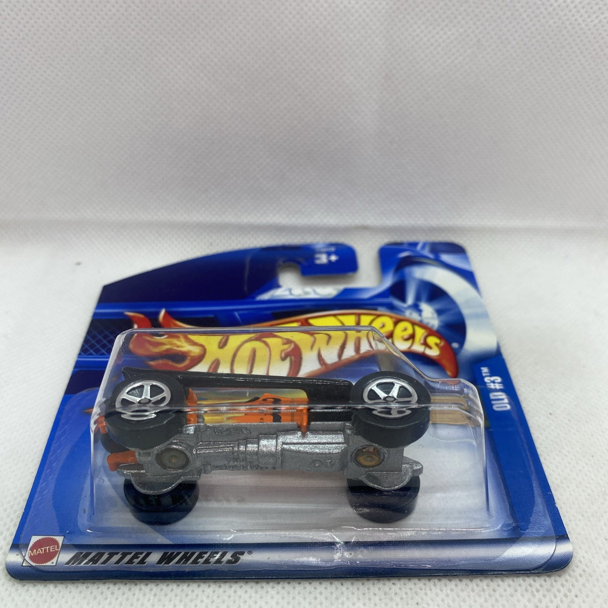Hot Wheels orange die-cast car side view in blue blister package with clear cover
