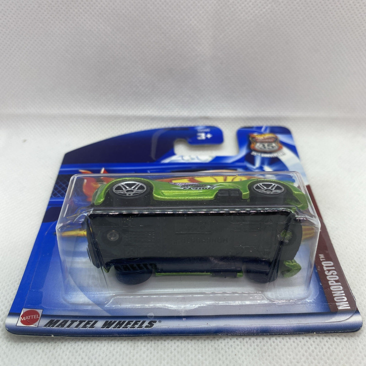 Unopened packaging with green race car inside clear blister on blue card