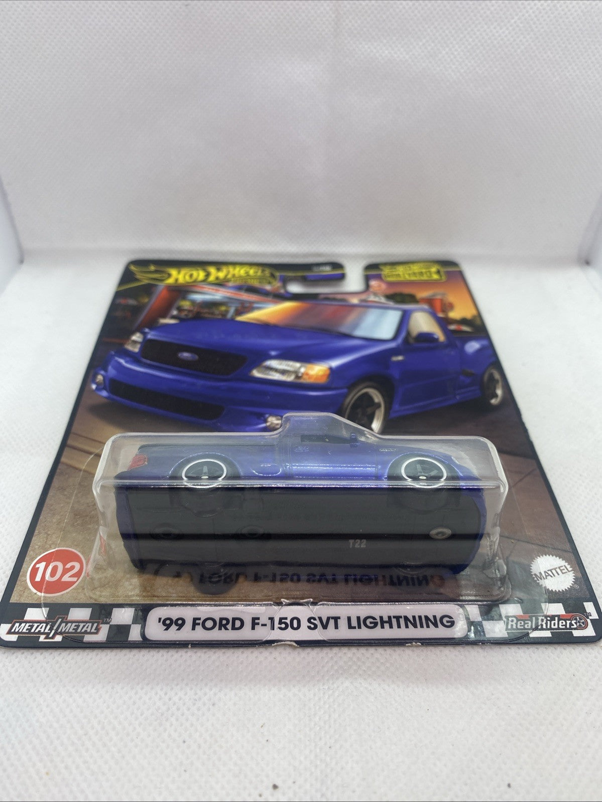 Blue F-150 SVT Lightning die-cast truck in blister on retail card, side view