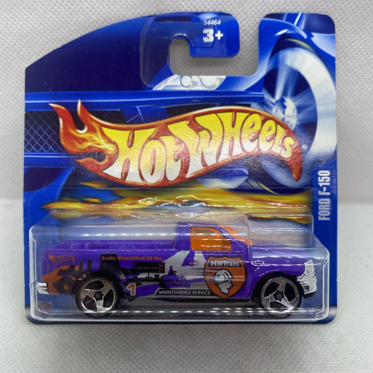 Hot Wheels purple 2002 Ford F-150 die-cast truck in sealed blister, side view