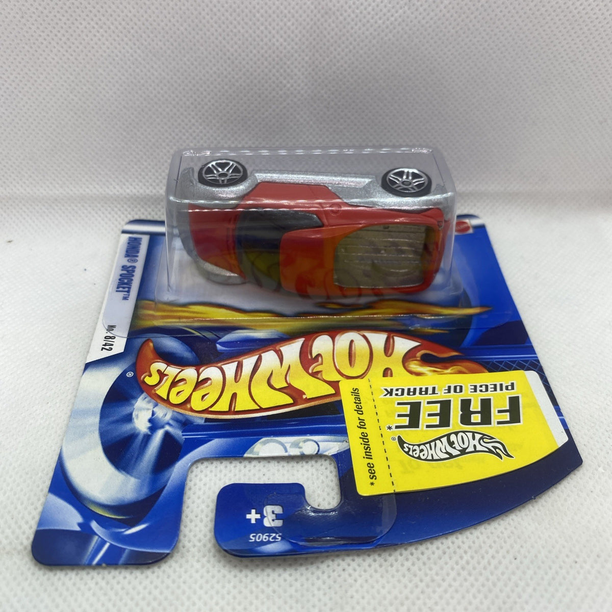 Hot Wheels car blister card with red and gray die-cast car under clear plastic
