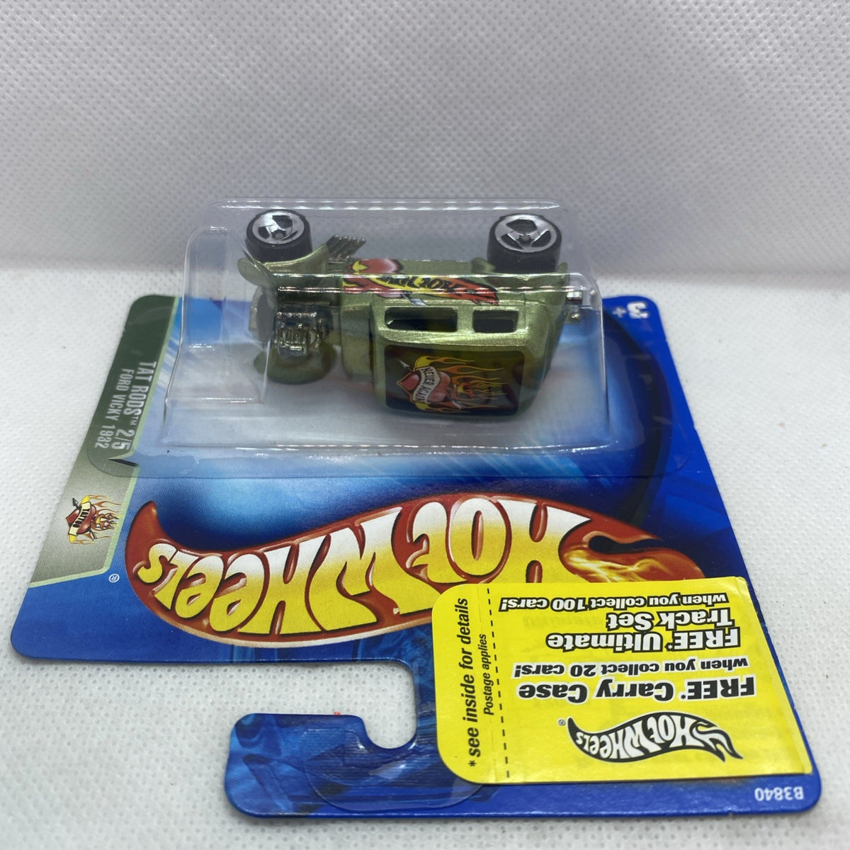 Hot Wheels die-cast green car in clear blister pack with top view on card