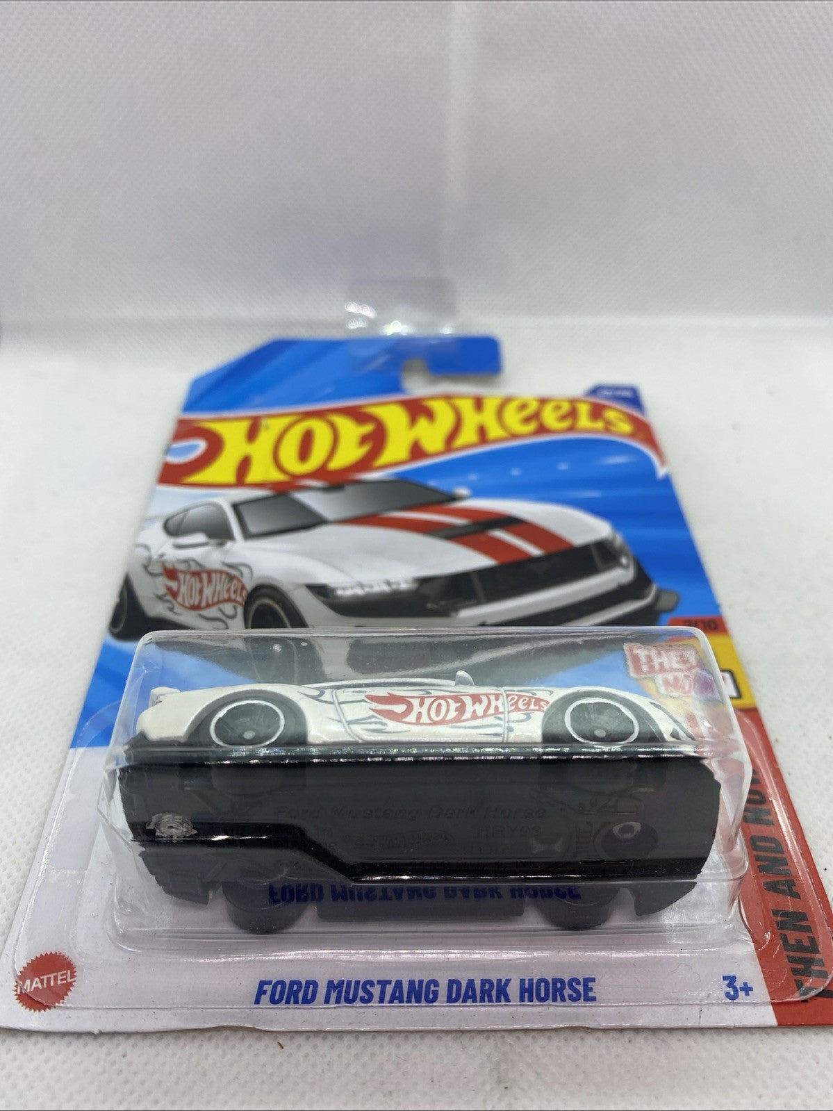 Hot Wheels blister pack showing white Ford Mustang Dark Horse with black wheels