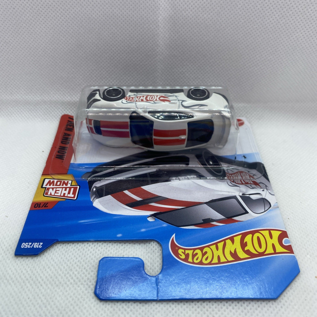 Hot Wheels car blister with white Ford Mustang Dark Horse, side view, red stripe decals