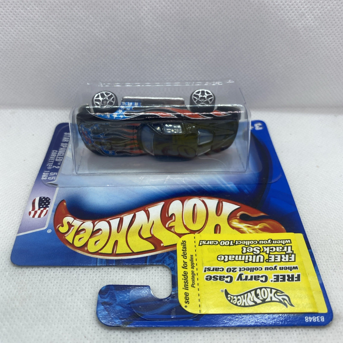 Hot Wheels Corvette die-cast car in clear blister, dark blue with orange flame stripes