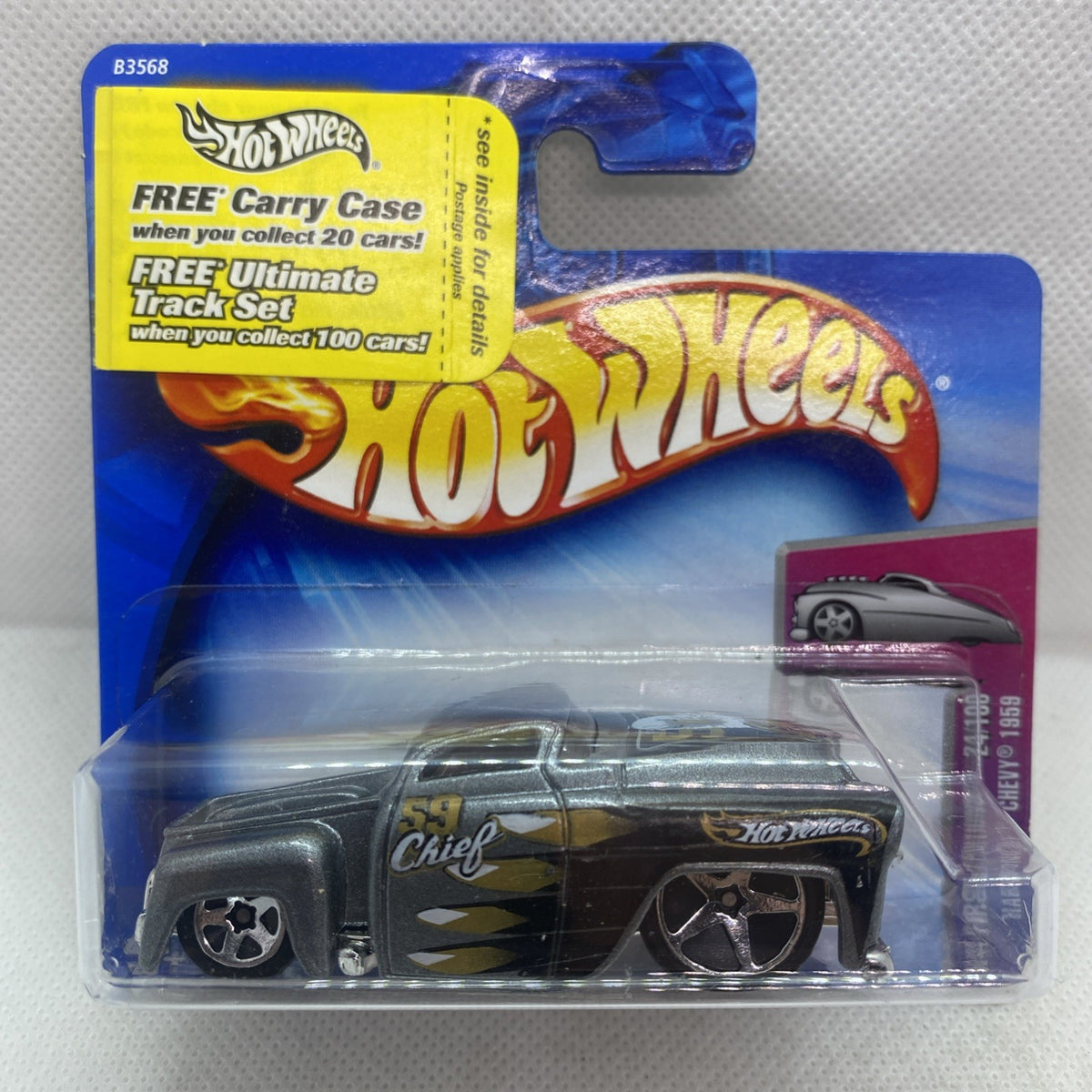 Toy die-cast car in clear blister on blue Hot Wheels card, dark gray with gold graphics