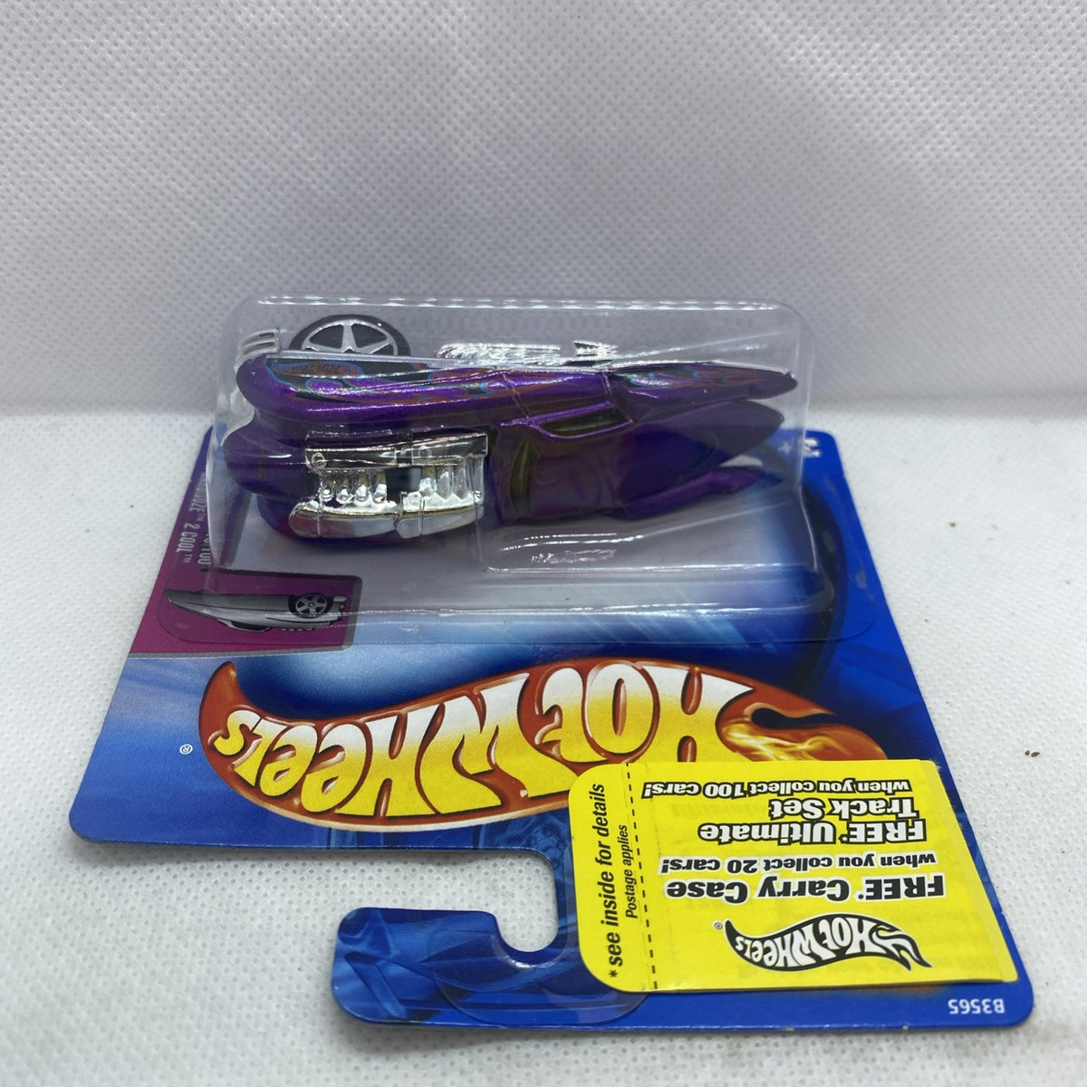 Hot Wheels die-cast car in blister, purple body with chrome engine detail on blue card