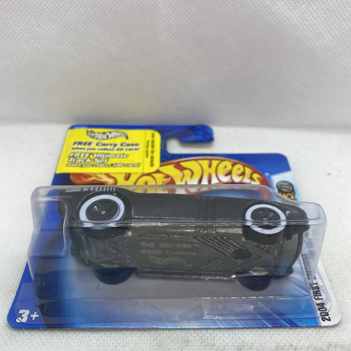 Hot Wheels die-cast car blister with top view, black body and silver wheel rims