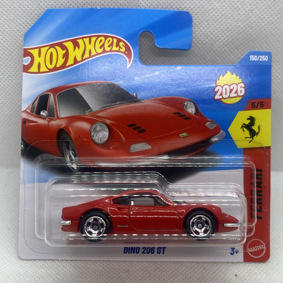 Red die-cast sports car on Hot Wheels blister card, front three-quarter view.