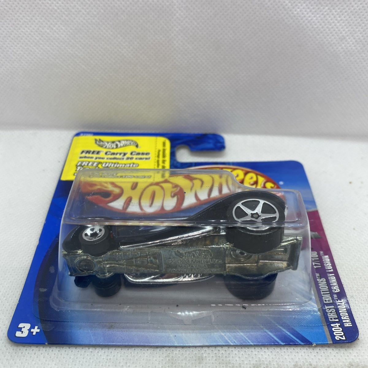 Hot Wheels short card blister with dark blue die-cast car and silver star-style wheel