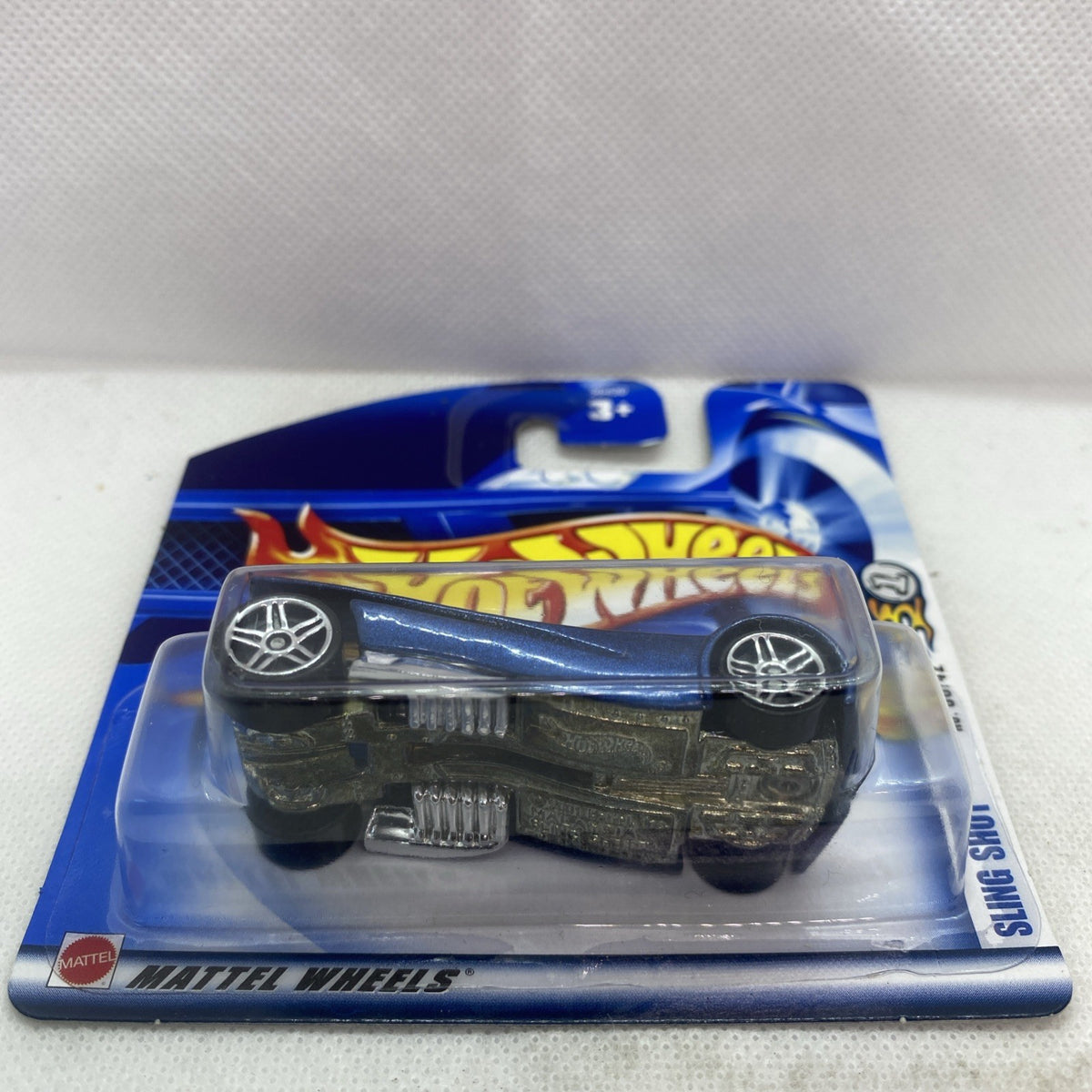 Hot Wheels die-cast car blister card side view with blue car and Mattel logo