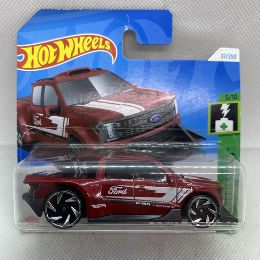 Maroon die-cast pickup truck toy in clear blister, black hood and white stripe
