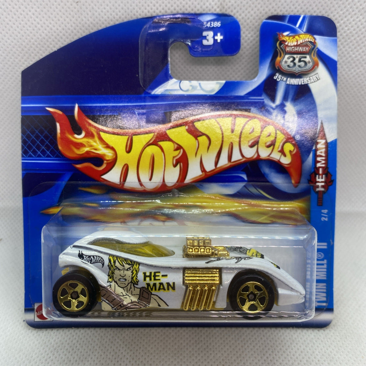 Hot Wheels die-cast car in sealed blister pack, white body with gold grille and He-Man art