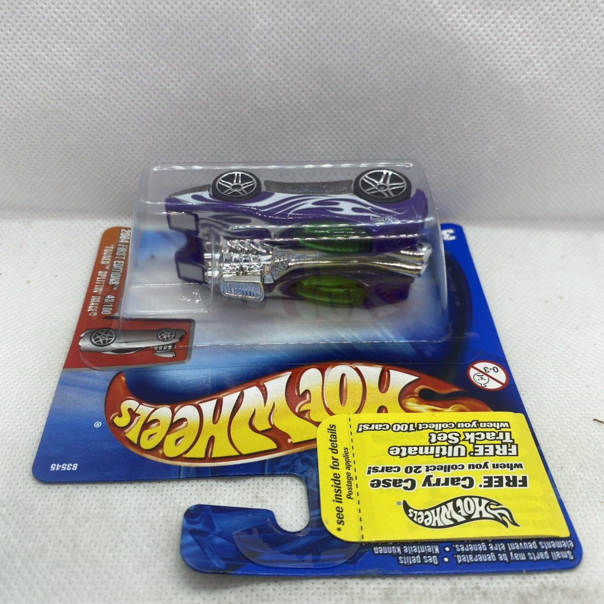 Hot Wheels die-cast car in blister pack with purple-and-green flame decals, sealed