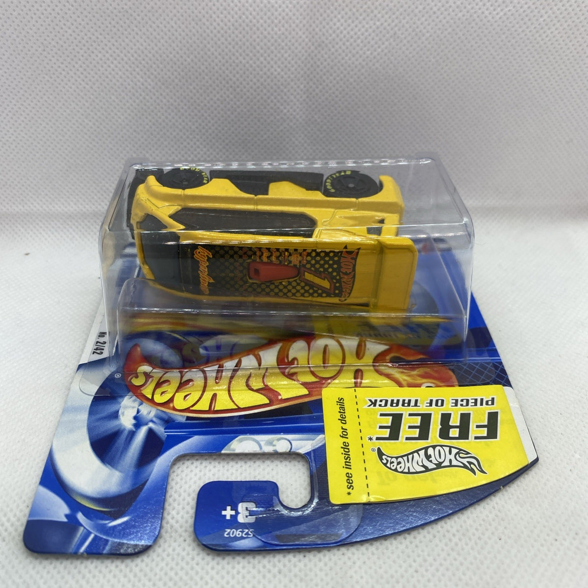 Hot Wheels yellow die-cast car in blister pack with card backing, sealed