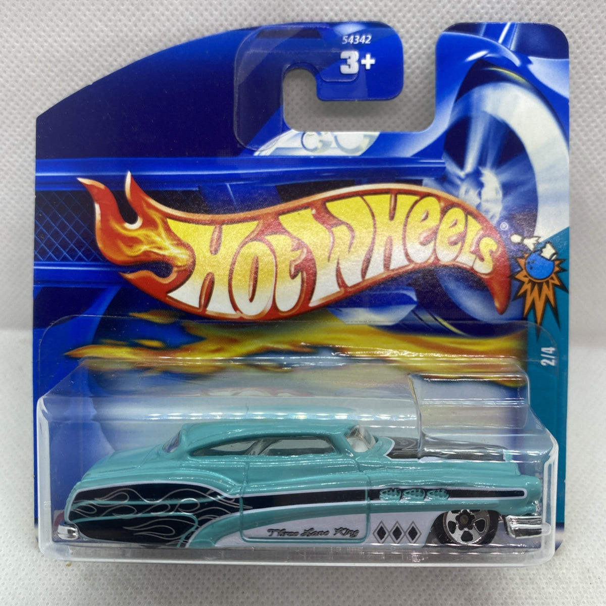 Teal die-cast truck in clear blister on blue short card, flame logo on card
