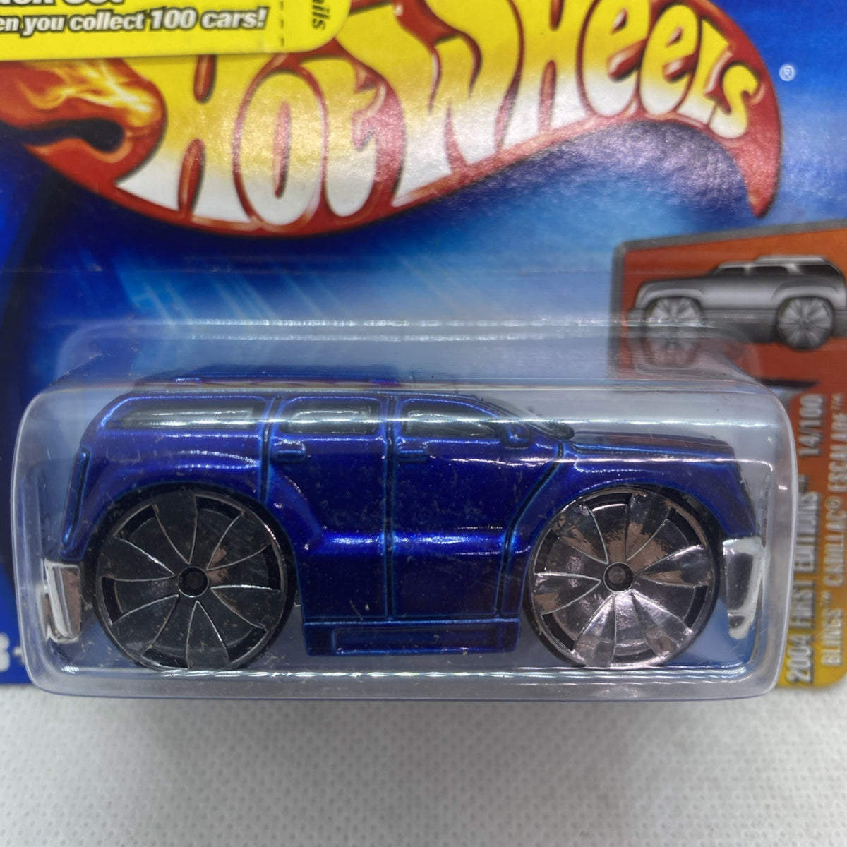 Blue SUV die-cast toy with black and chrome wheels in clear blister pack