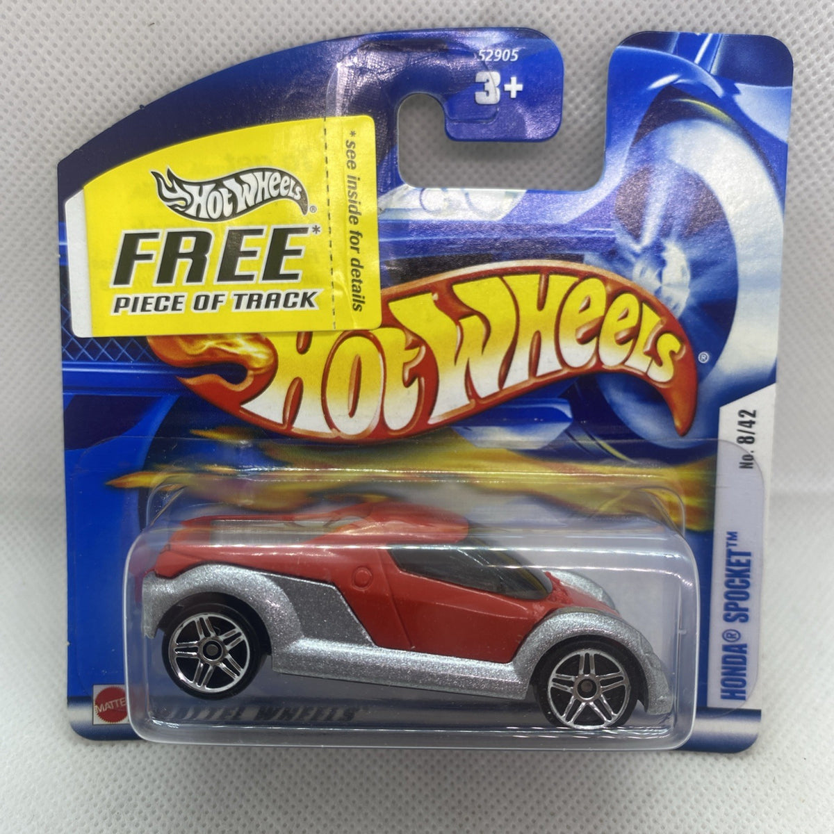 Hot Wheels die-cast car on blue blister card, red and gray with black details