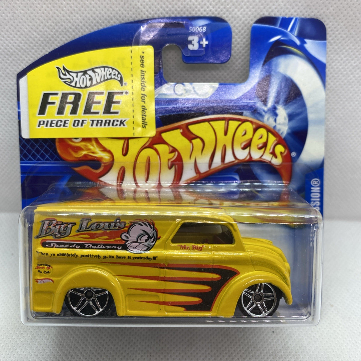 Yellow Hot Wheels die-cast pickup in clear blister on blue card, flame graphics.