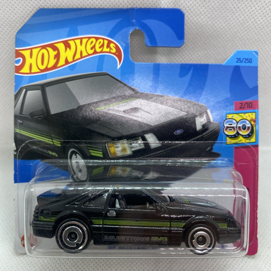 Black die-cast Mustang SVO with green racing stripes in clear blister pack