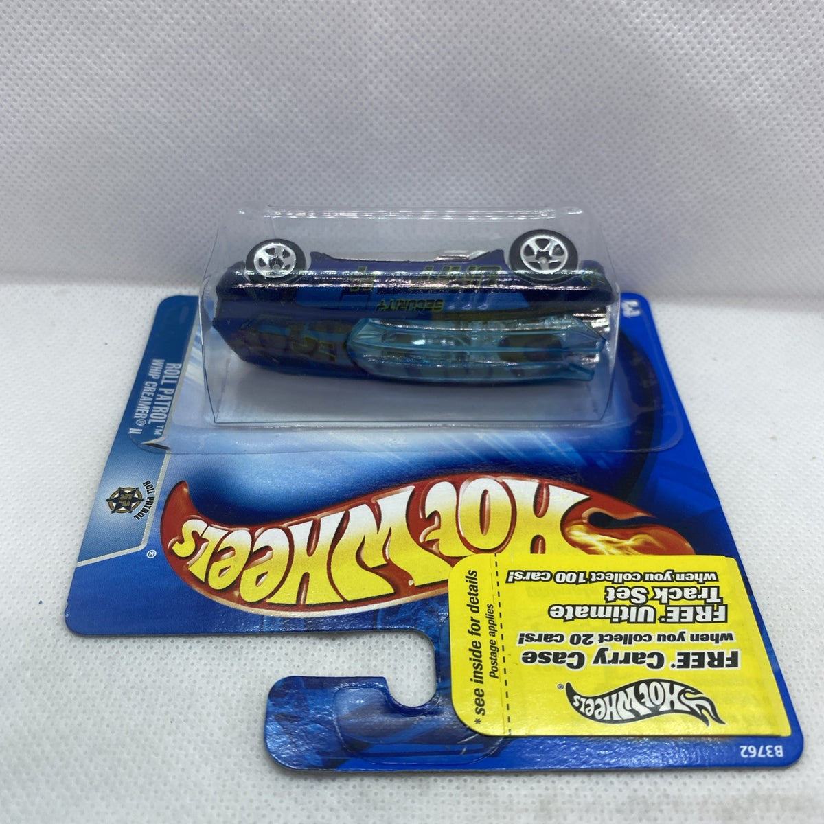 Blue Hot Wheels car in clear blister on blue card, wheels visible, sealed packaging