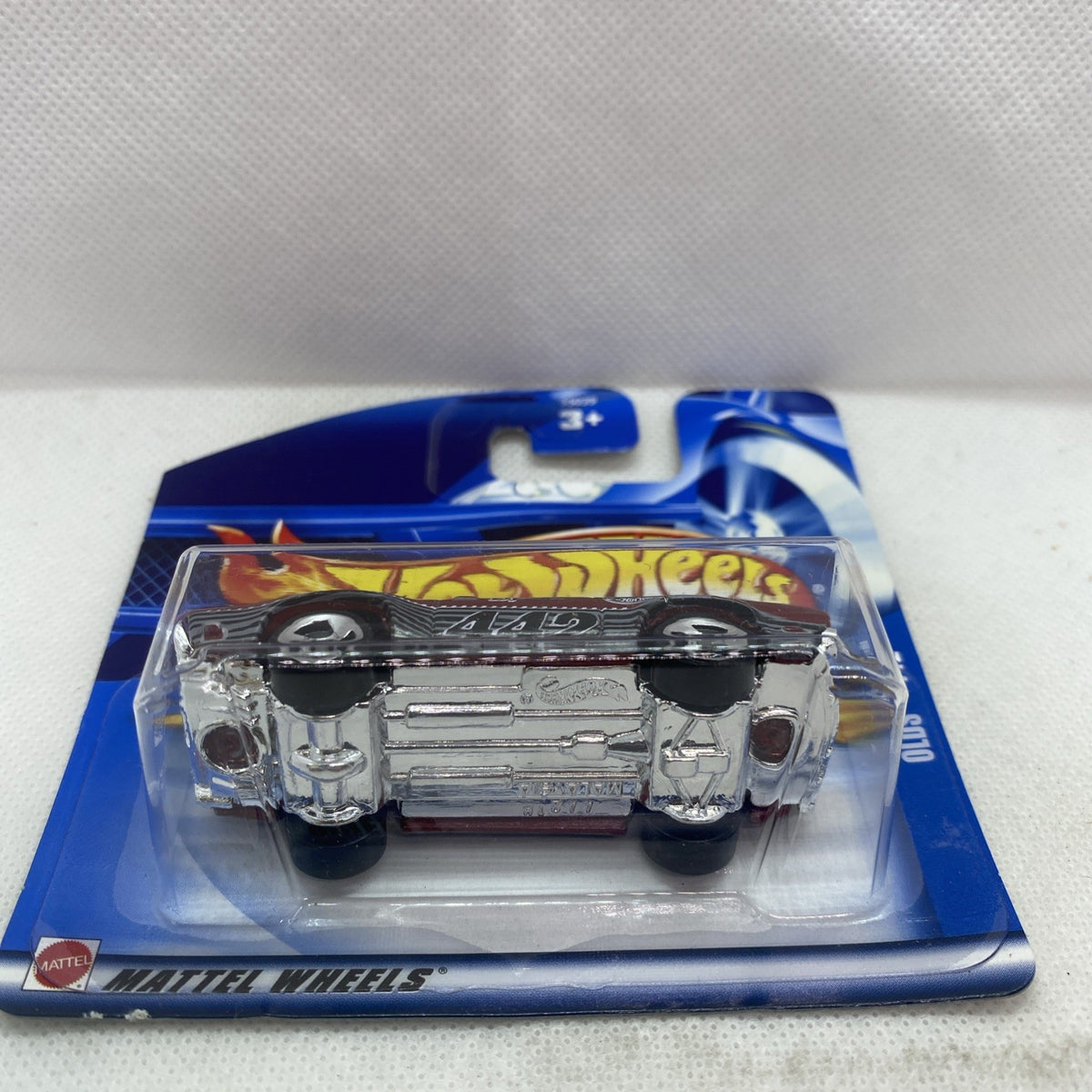 Hot Wheels die-cast Olds 442 car on blister card, maroon body with chrome details
