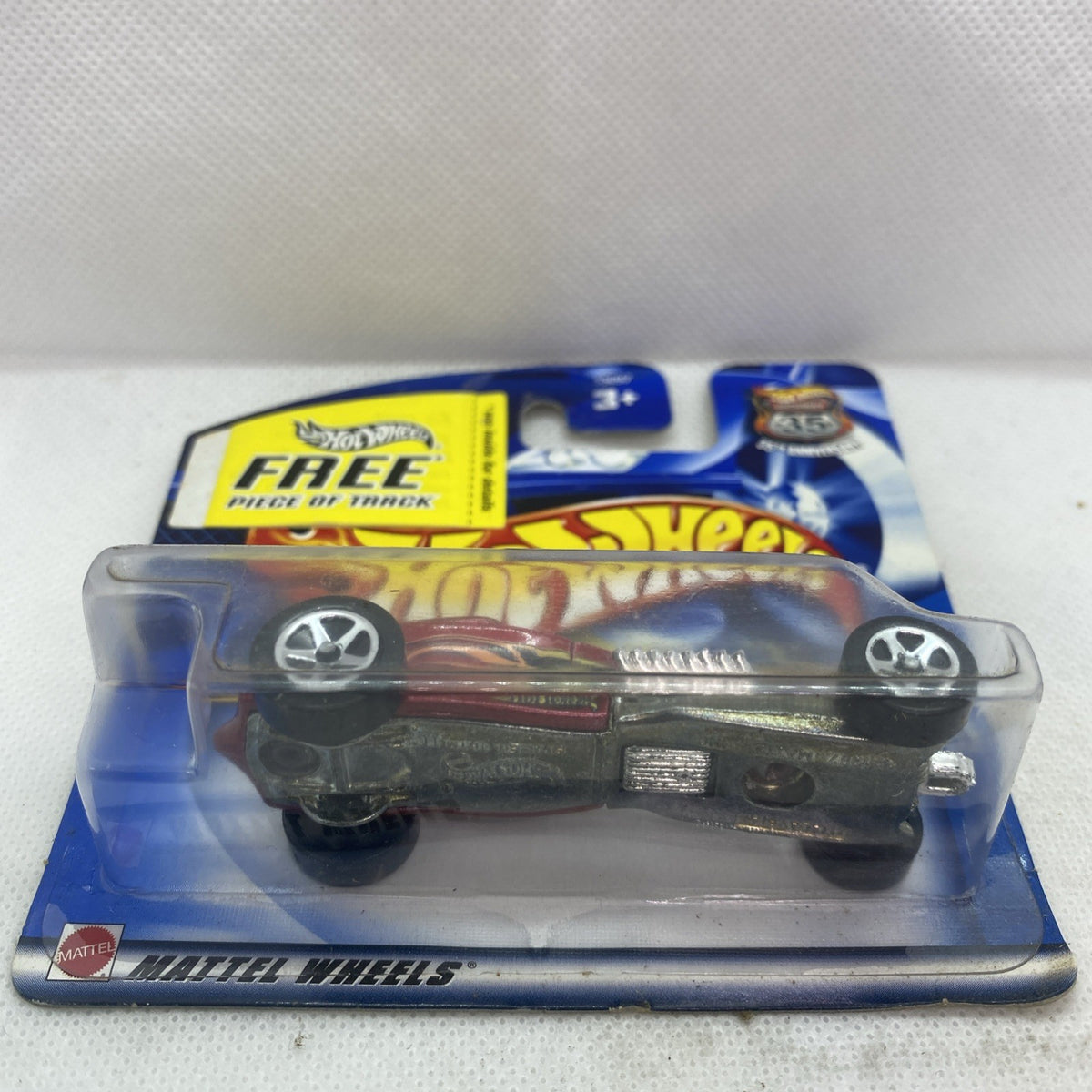 Hot Wheels die-cast car in blister pack, maroon and silver body with flame decals
