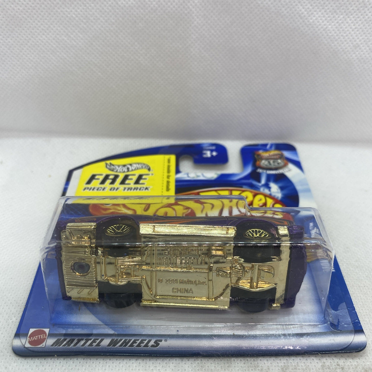 Hot Wheels blister card with metallic gold die-cast car, side view