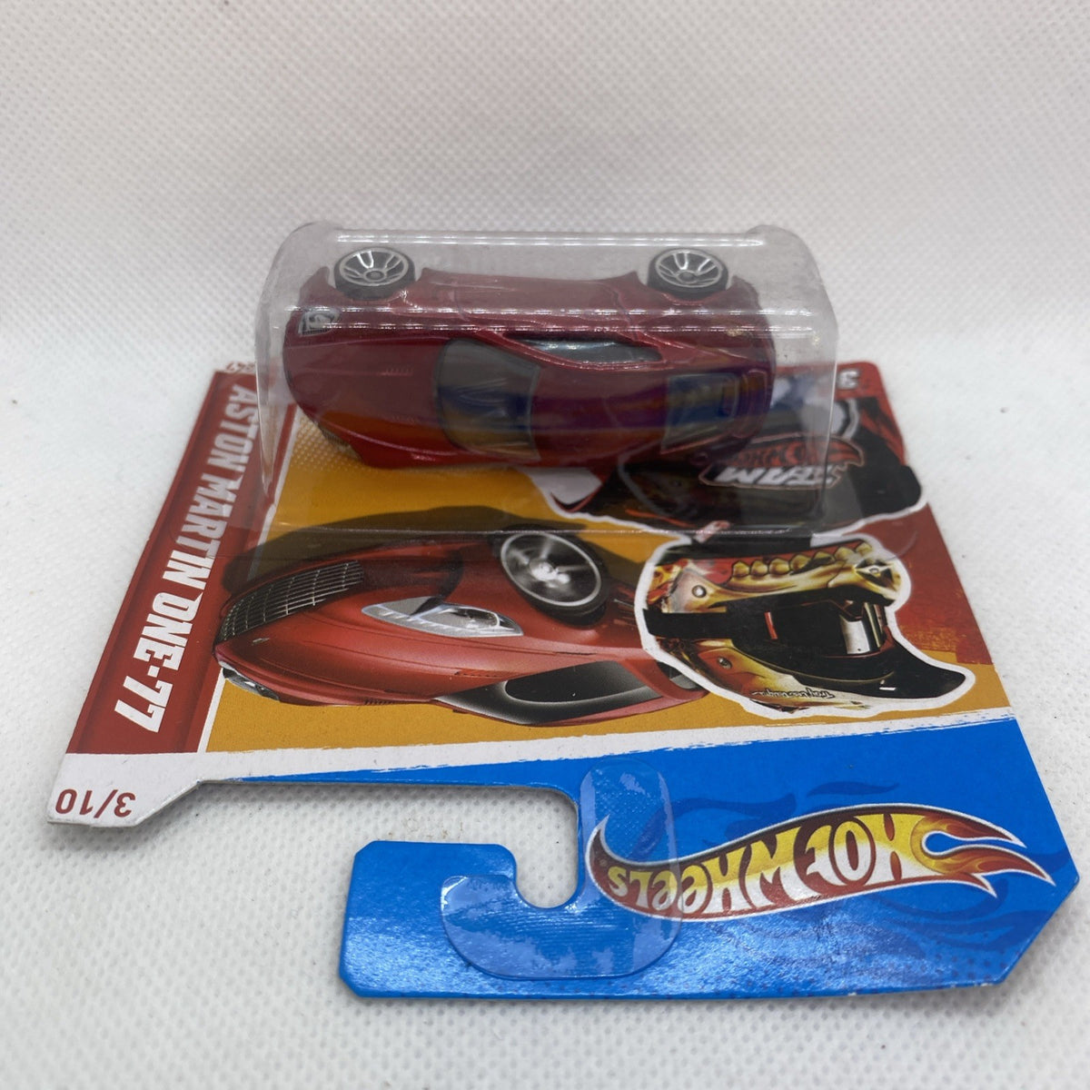 Red Aston Martin One-77 diecast car in clear blister on Hot Wheels blue card