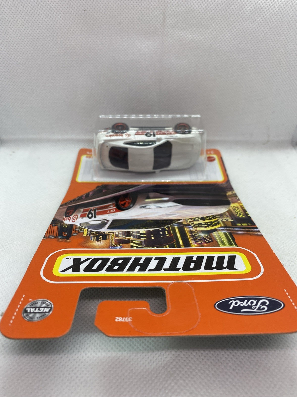 Matchbox toy car blister on orange card, top view of '19 Ford Mustang Coupe