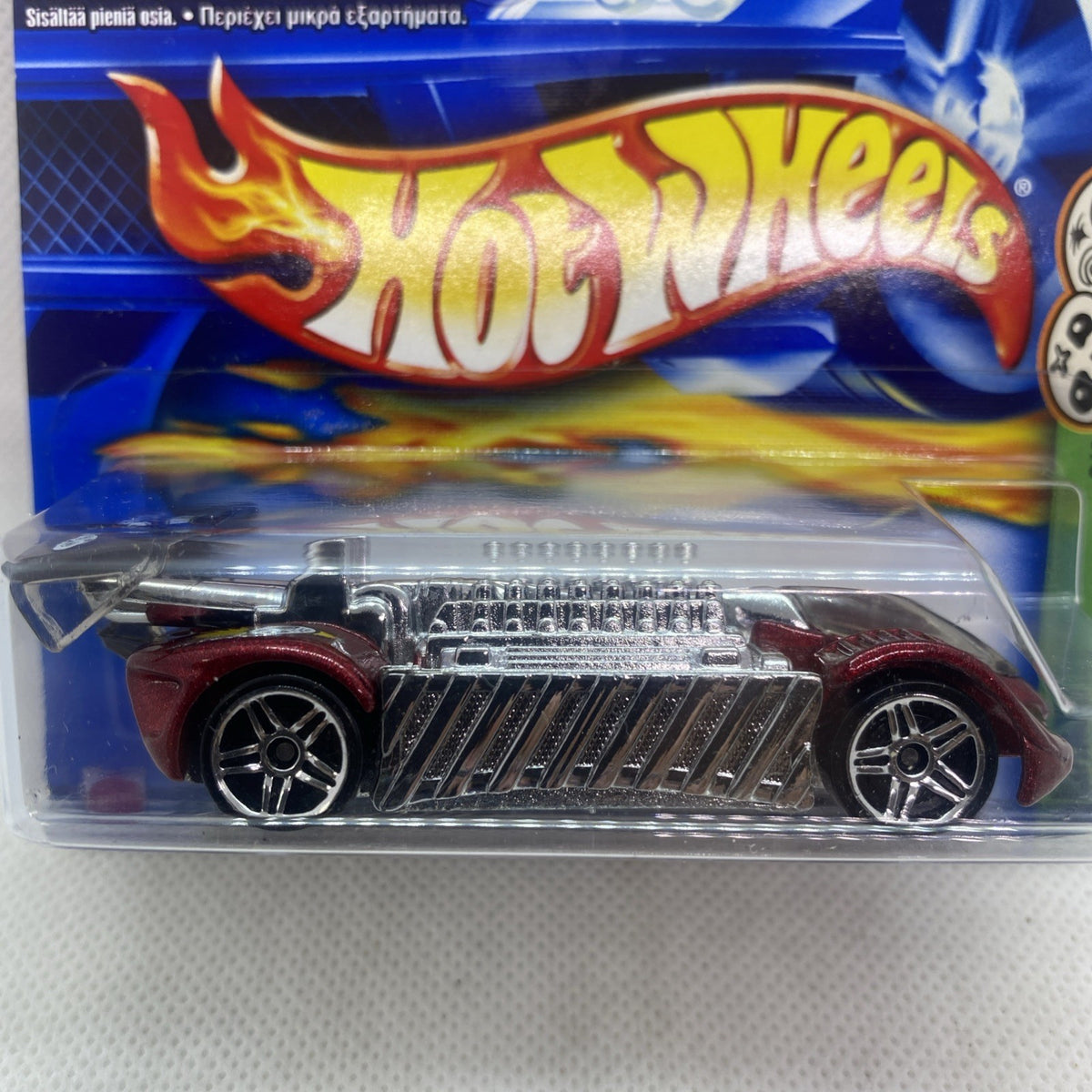 Hot Wheels die-cast car in blister pack, front view with flame graphics