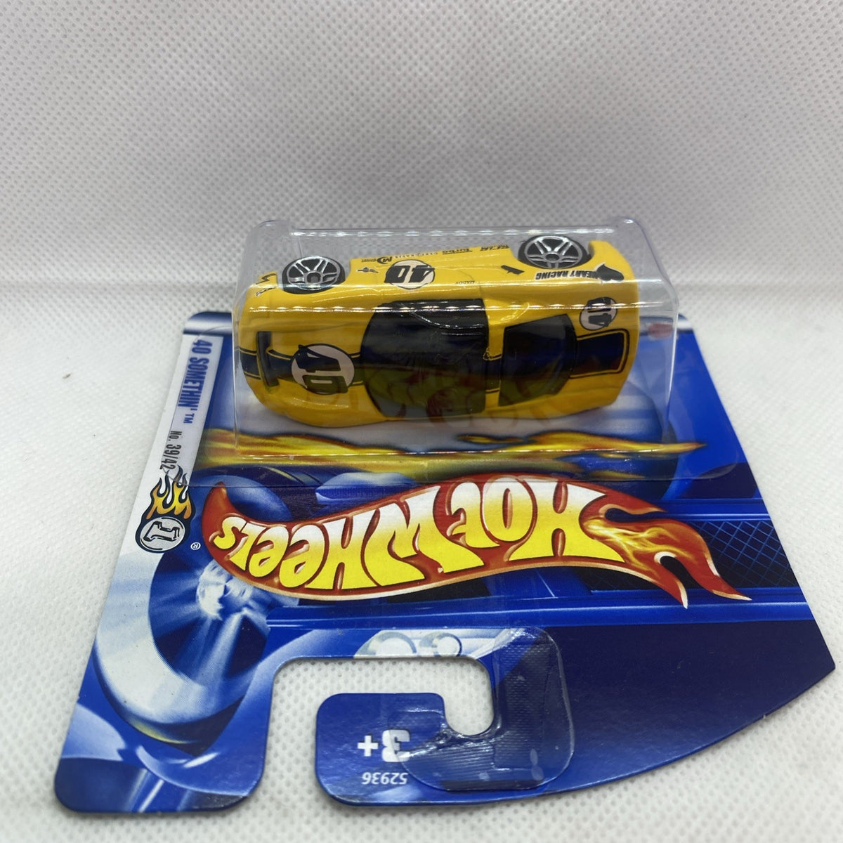 Sealed yellow Hot Wheels car blister pack on blue card with flame logo