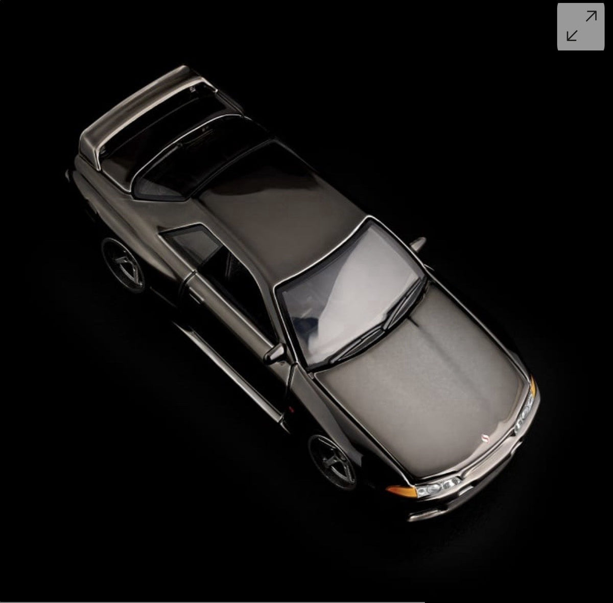 Die-cast sports car model, angled top view with hood open and exposed engine area