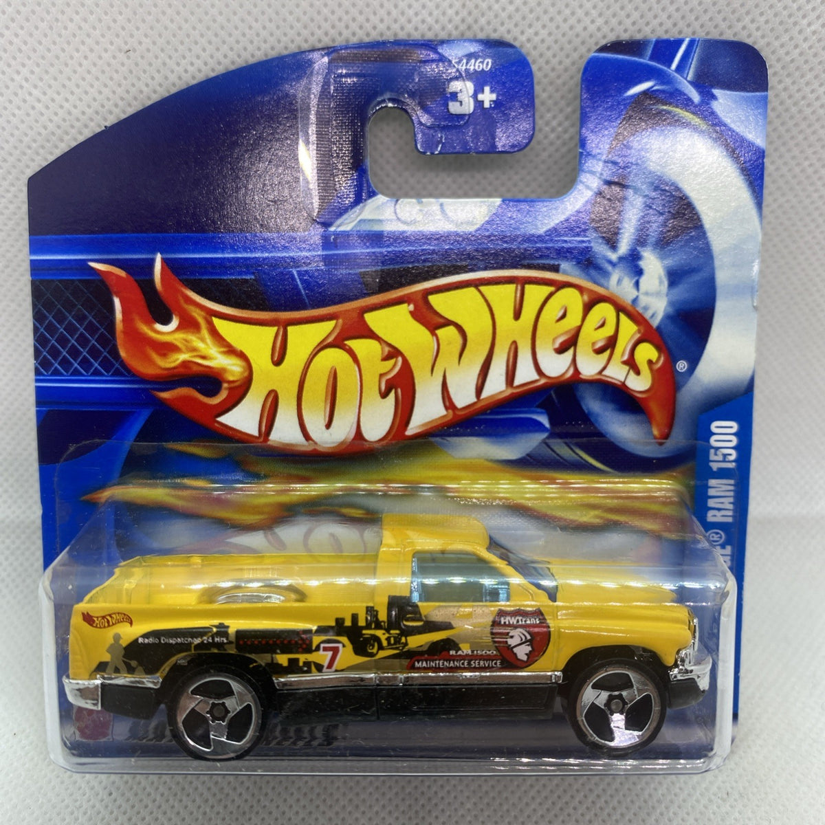 Hot Wheels die-cast Dodge Ram 1500 toy in clear blister card, yellow and black.