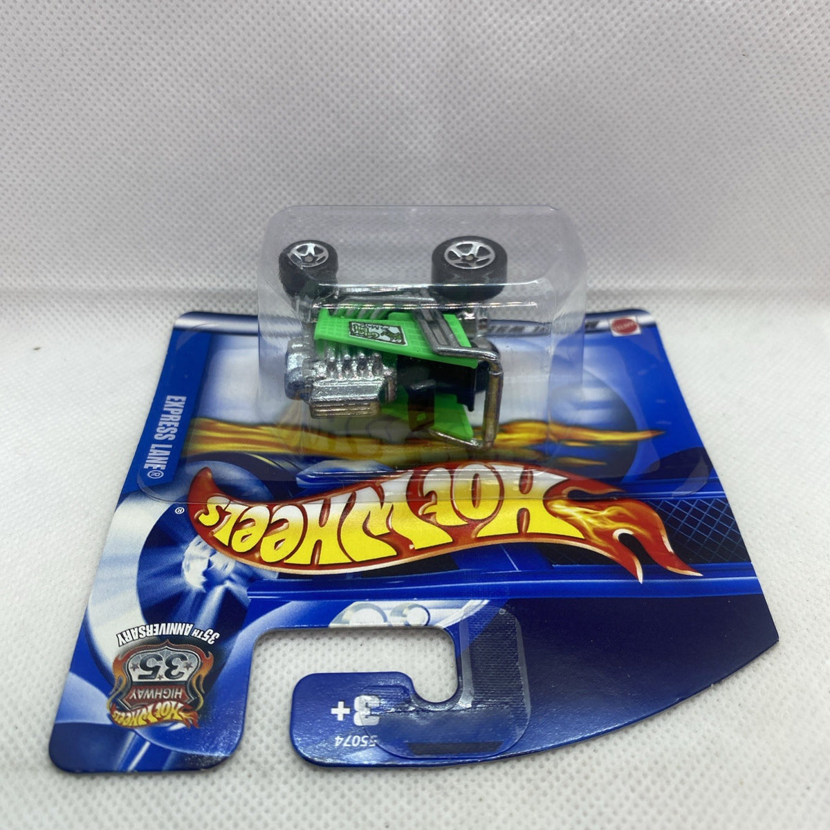 Green and black toy car on Hot Wheels blister card with Express Lane branding