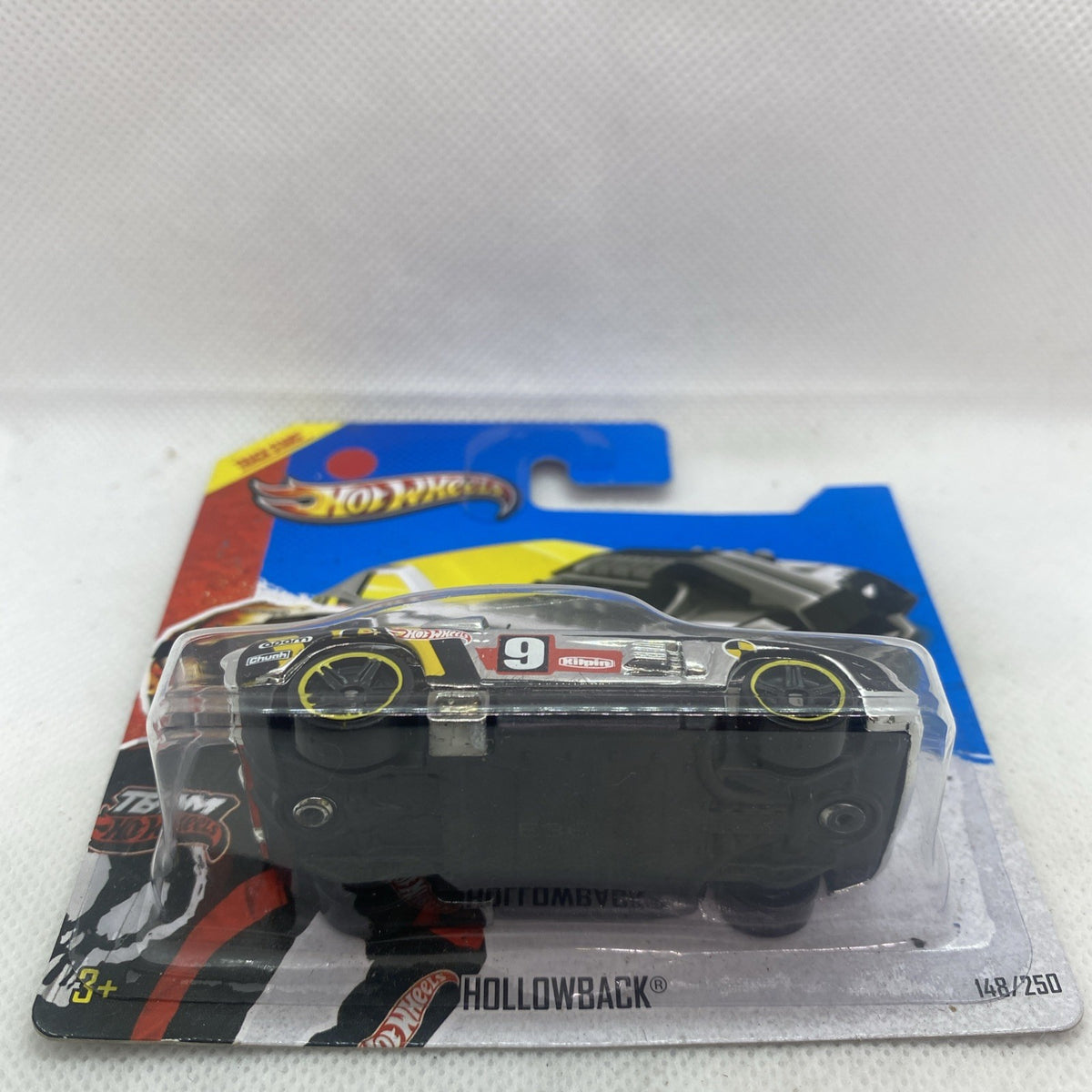 Hot Wheels diecast race car front view in clear blister, black body with number 9