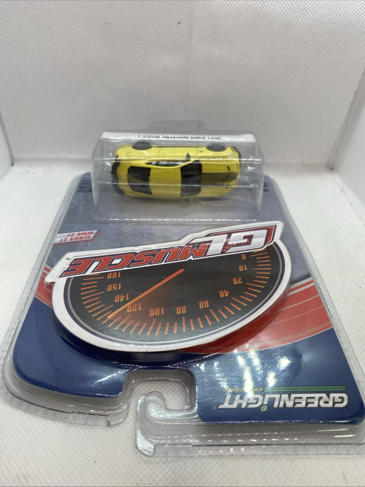 Sealed 1:64 yellow 2021 Ford Mustang Mach 1 die-cast car in blister packaging