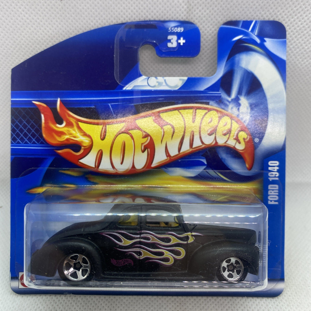 Black 1940 Ford Coupe toy car in sealed Hot Wheels blister pack with flame graphics