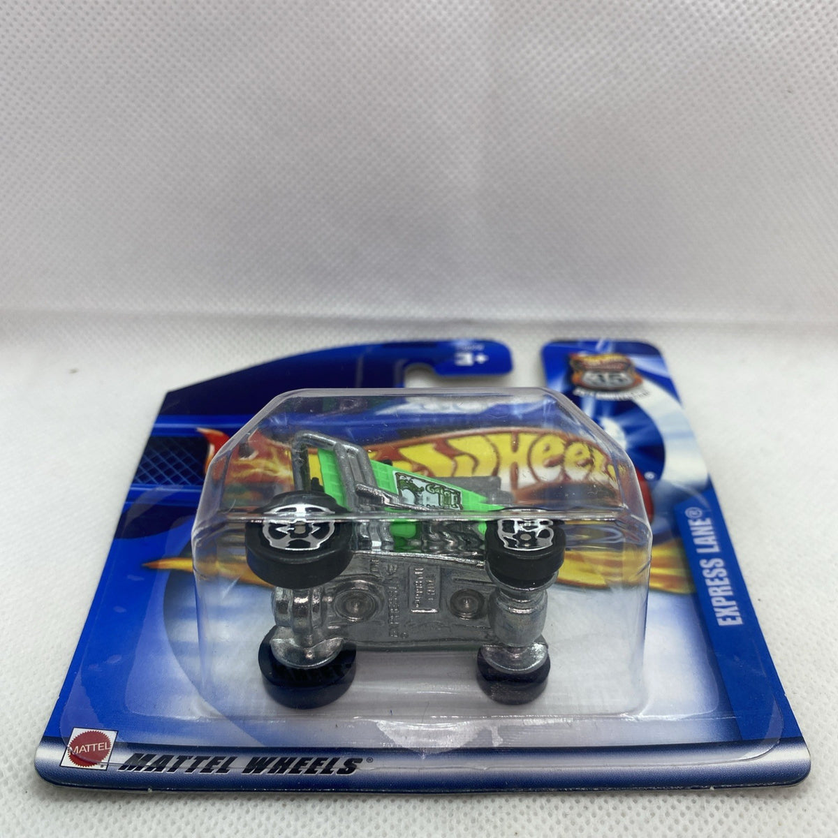 Green and black toy car in clear blister on blue Hot Wheels card