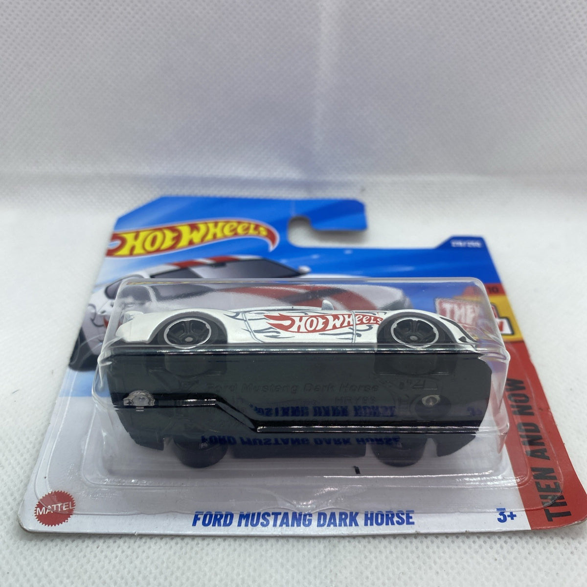Hot Wheels Ford Mustang Dark Horse toy car in sealed blister, white body with red accents