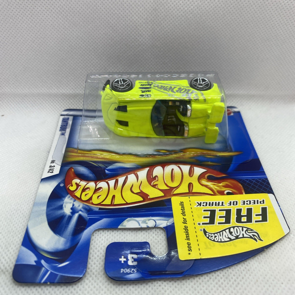 Hot Wheels carded neon lime die-cast car with black interior in clear blister