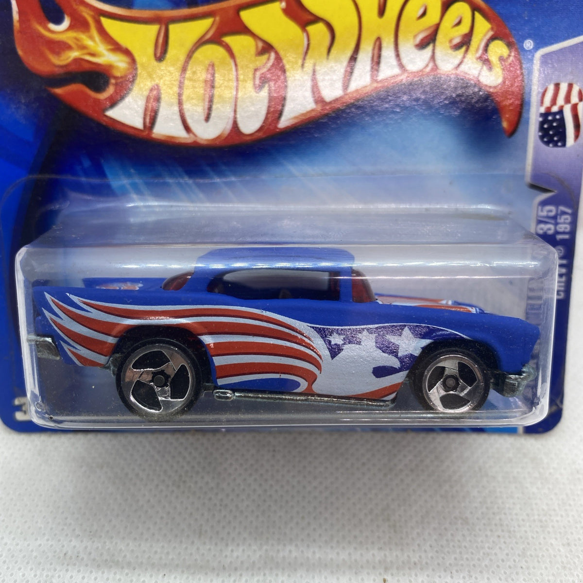 Die-cast car close-up in blister, blue body with red-white flames and star-spangled sides