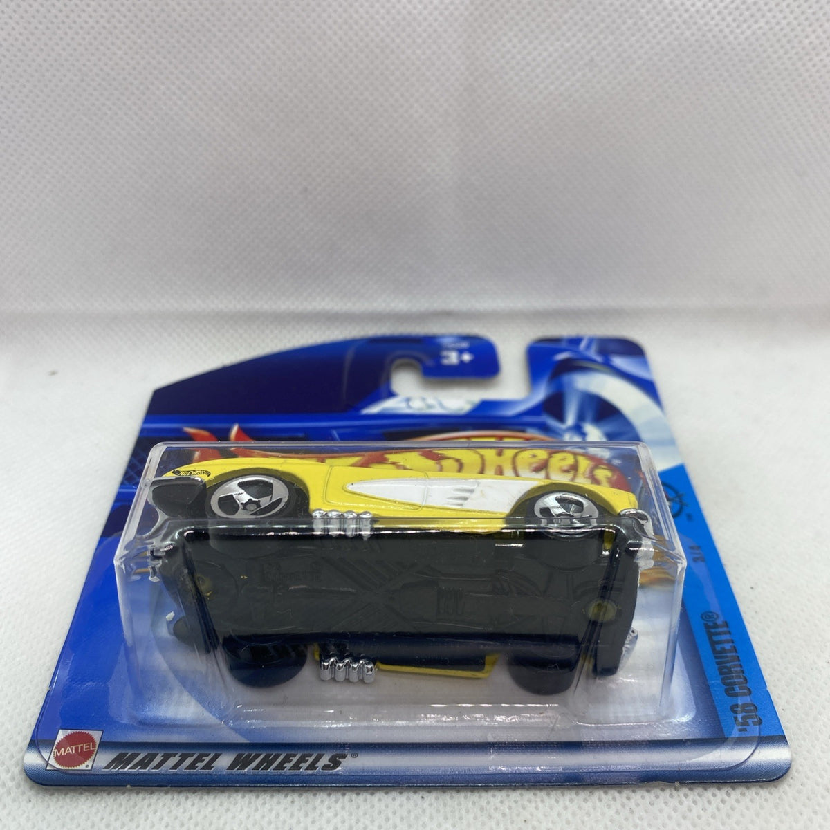 Hot Wheels 2002 Corvette #069 yellow die-cast car side view in sealed blister