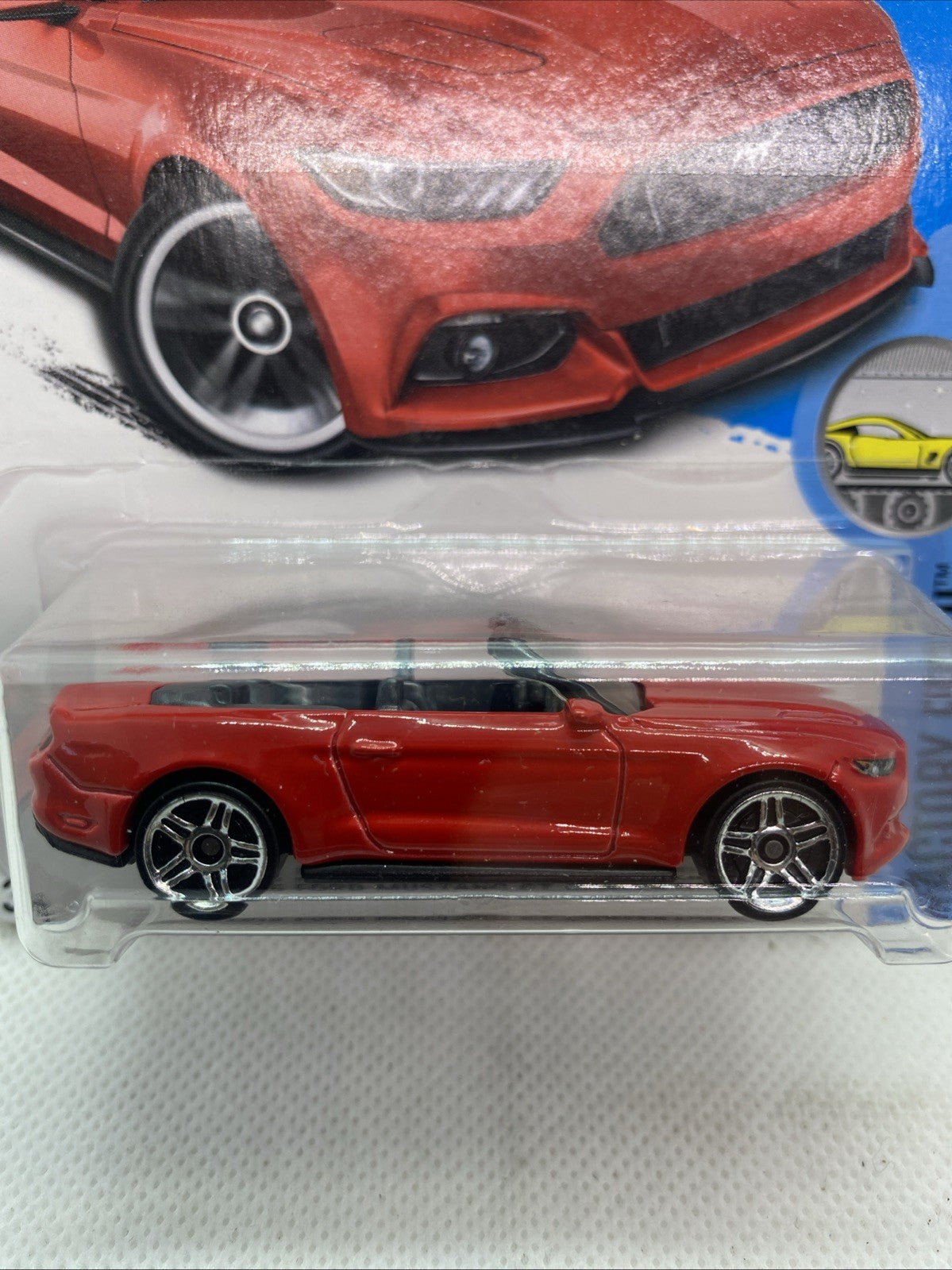 Hot Wheels red Mustang convertible toy, side view with chrome wheels in blister