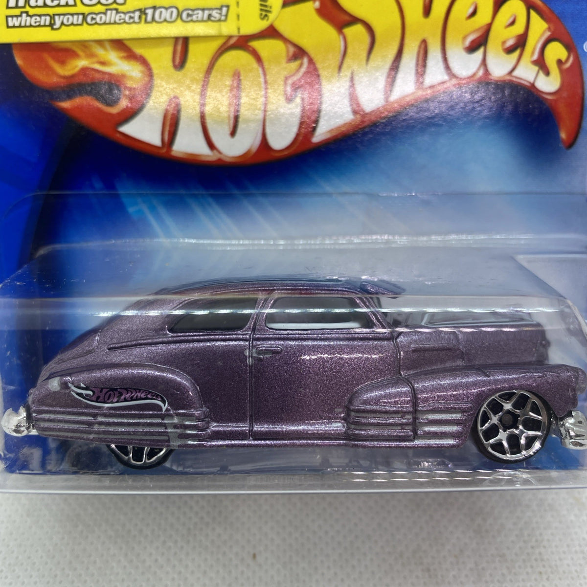 Hot Wheels diecast car blister pack close-up of maroon car side with chrome wheels
