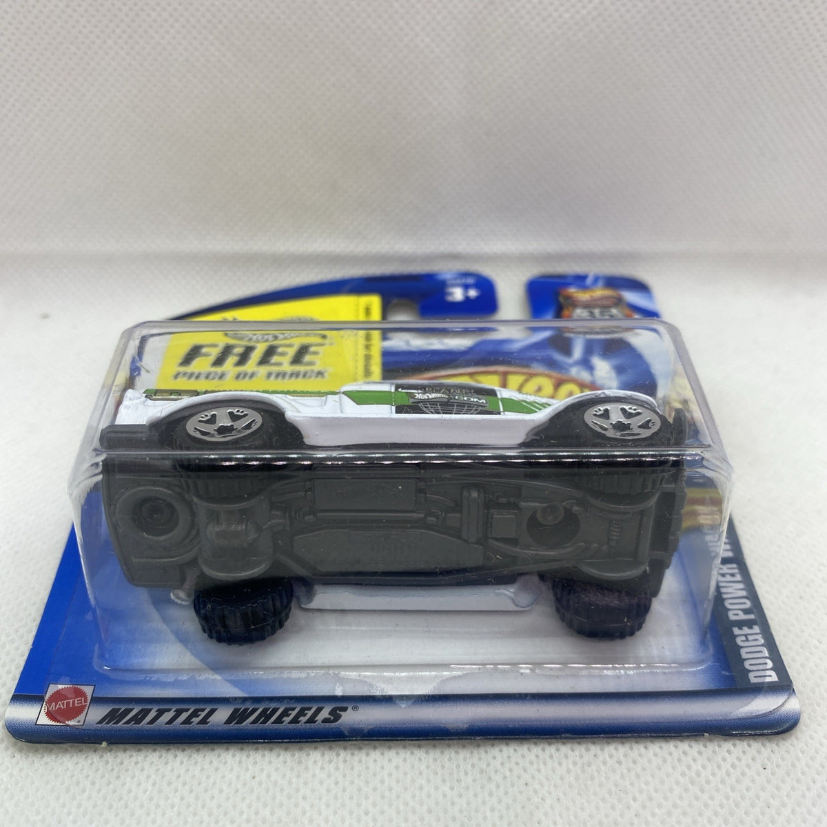 Hot Wheels die-cast truck on blister card, underside and wheels shown, rear view