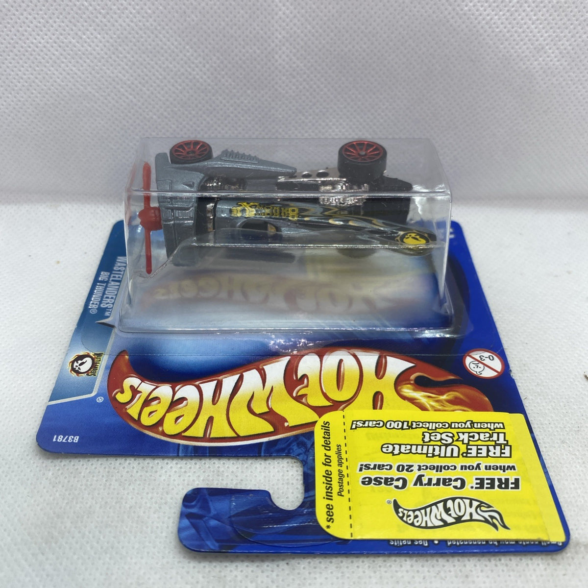 Hot Wheels die-cast truck in blister package, angled view showing wheels