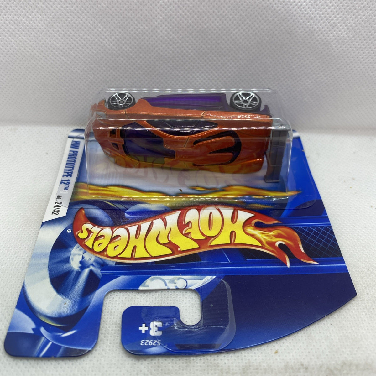 Hot Wheels die-cast car in blister, orange with flame graphics, purple accents, sealed