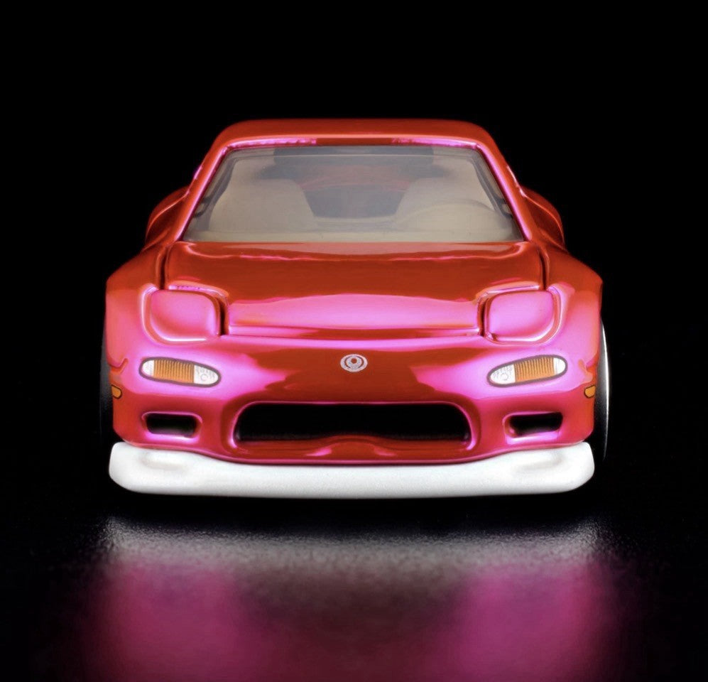 Pink and orange die-cast sports car front view with chrome wheels